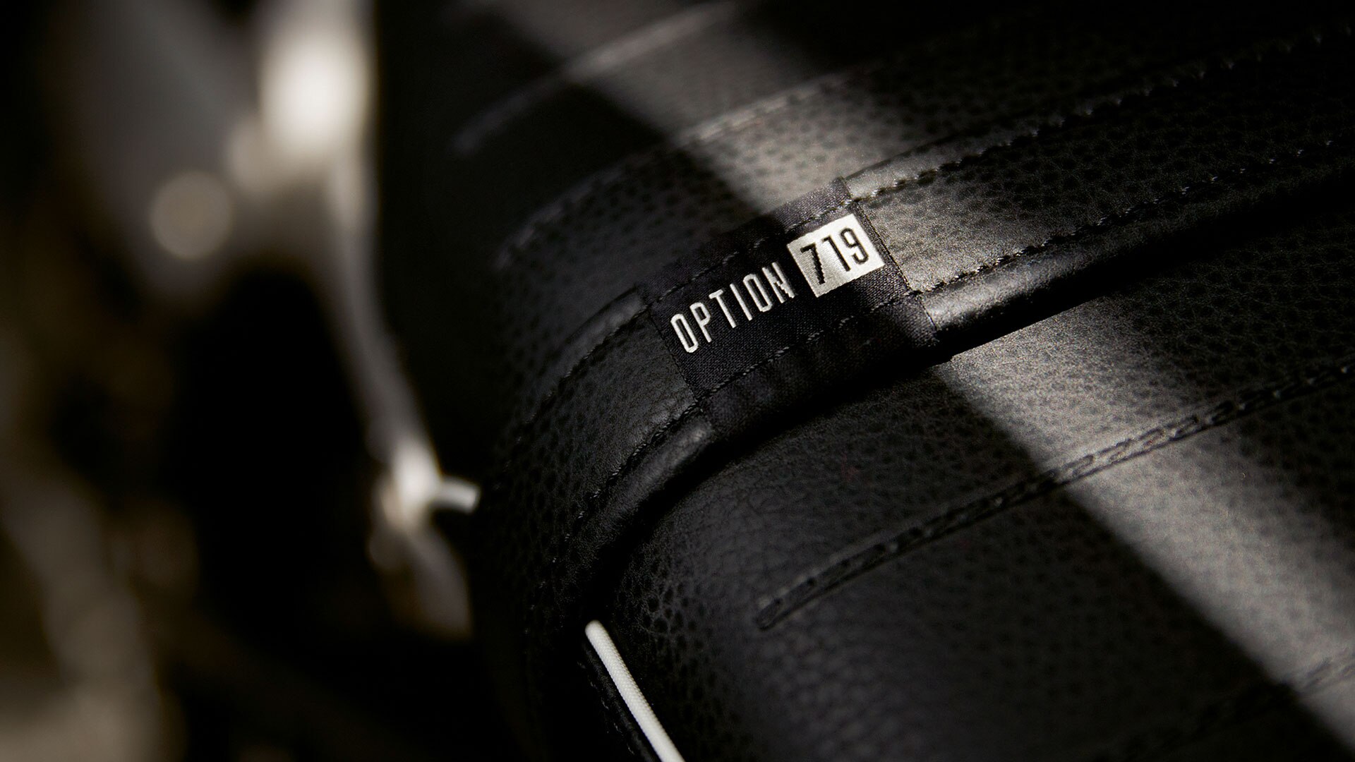 Detail shot of the seat bench with Option 719 label and white edge stripping.
