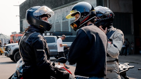 We see two riders in front of a dealership